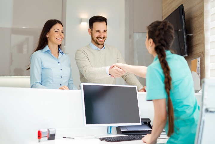 Tahoe Oral Surgery receptionist shaking a clients hand